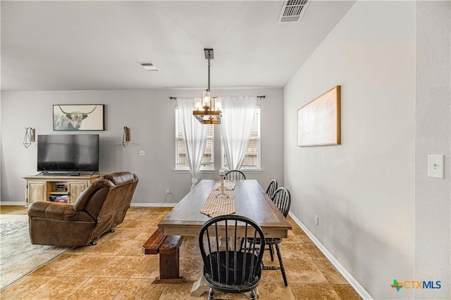 dining space with baseboards, a notable chandelier, and visible vents