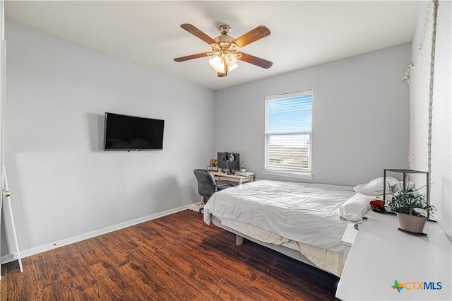 bedroom with baseboards, ceiling fan, and wood finished floors