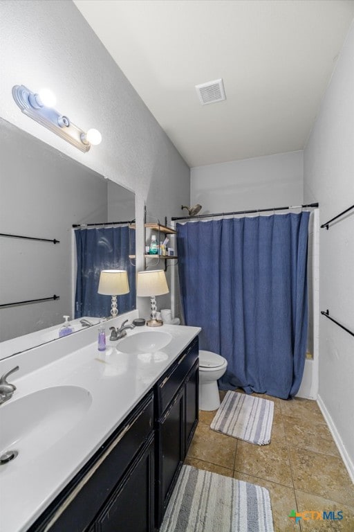 full bathroom with a sink, a shower with shower curtain, toilet, and visible vents