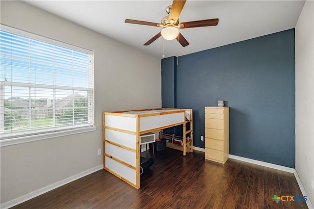 bedroom featuring baseboards, a ceiling fan, and wood finished floors
