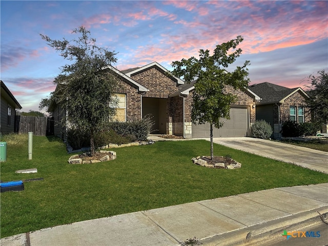 view of front of house featuring a yard and a garage