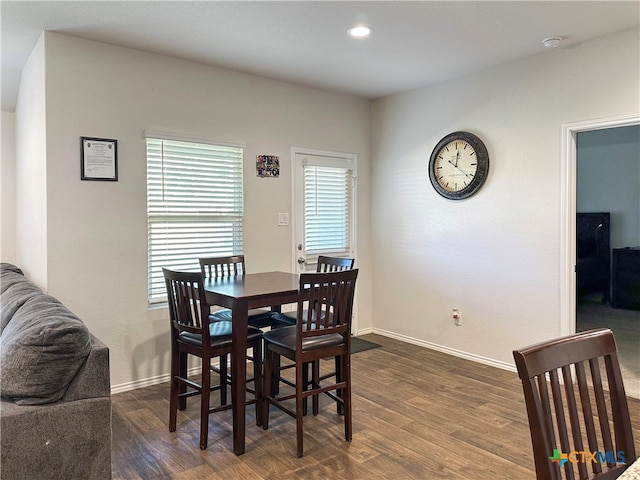 dining space featuring dark wood-type flooring