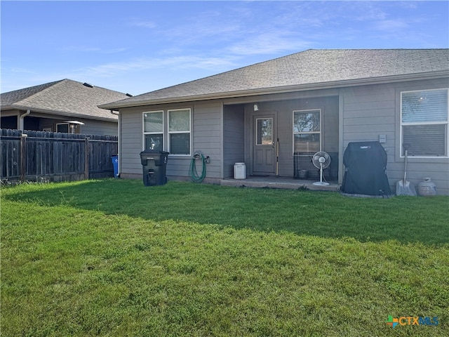 back of house with a lawn