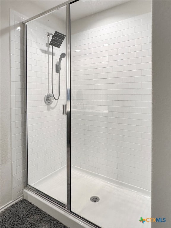 bathroom with a shower with shower door