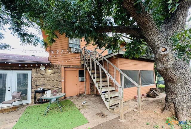 back of property with a sunroom