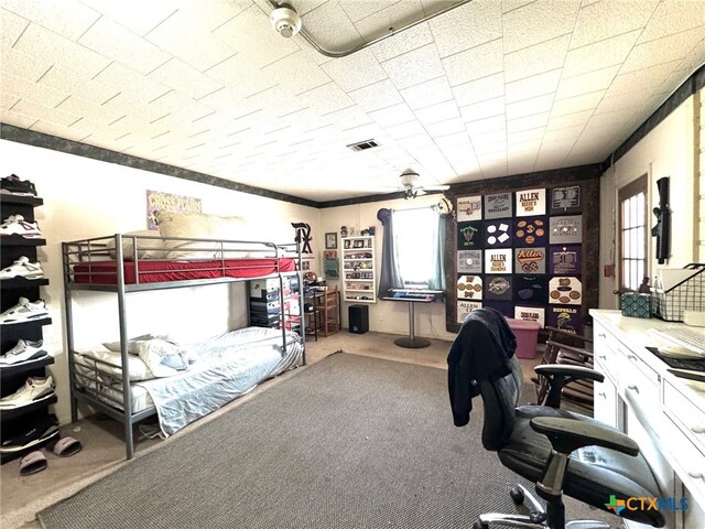 bedroom with ceiling fan, multiple windows, and carpet