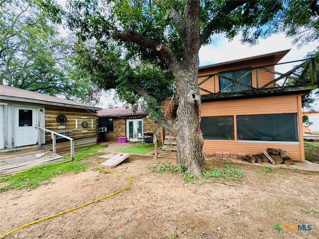 rear view of house featuring a patio and a sunroom