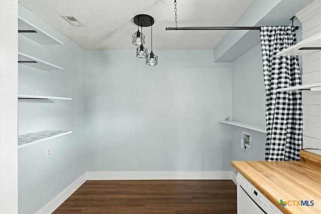 spacious closet with visible vents and dark wood-type flooring