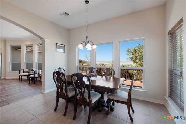 115 Scarlet Ct, Canyon Lake, TX 78133 - dining room featuring a notable chandelier, arched walkways, visible vents, and baseboards