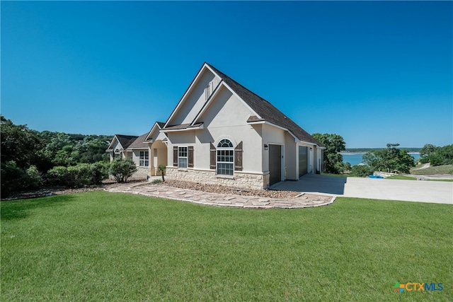 115 Scarlet Ct, Canyon Lake, TX 78133 - rear view of property featuring a garage, a lawn, stone siding, concrete driveway, and stucco siding