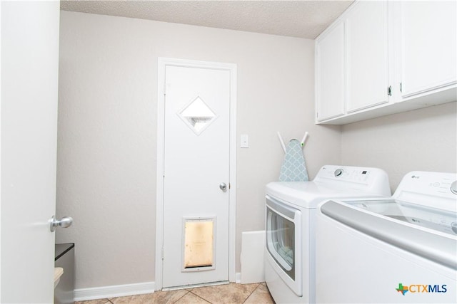 812 Trail Crest Dr, Harker Heights, TX 76548 - laundry room featuring cabinet space, a textured ceiling, baseboards, light tile patterned floors, and washing machine and dryer