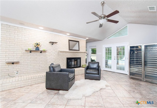 812 Trail Crest Dr, Harker Heights, TX 76548 - living room with ceiling fan, brick wall, a brick fireplace, tile patterned floors, and beverage cooler