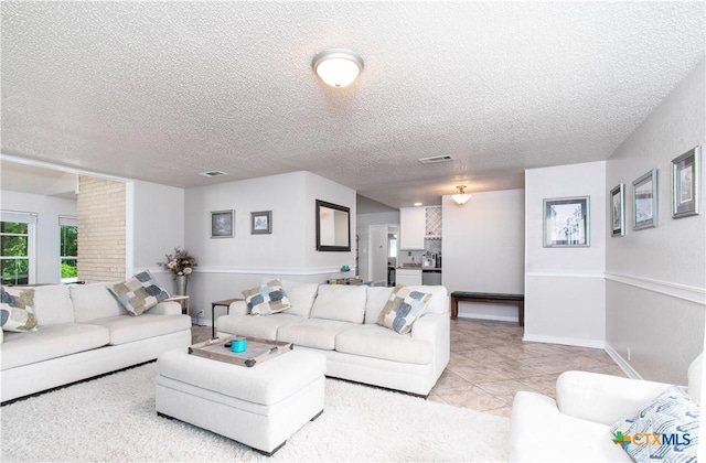 812 Trail Crest Dr, Harker Heights, TX 76548 - living room with baseboards, a textured ceiling, visible vents, and light tile patterned floors