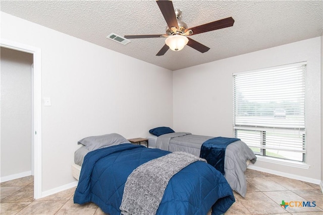 812 Trail Crest Dr, Harker Heights, TX 76548 - bedroom featuring a textured ceiling, a ceiling fan, baseboards, light tile patterned floors, and visible vents