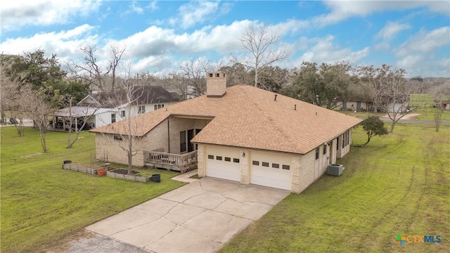 view of property exterior with a chimney, a lawn, an attached garage, cooling unit, and driveway