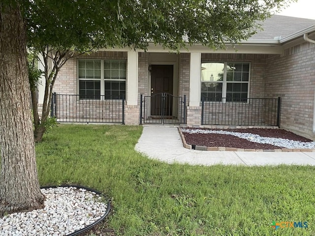 109 Hidden Mesa, Cibolo, TX 78108 - entrance to property with covered porch, brick siding, and a lawn