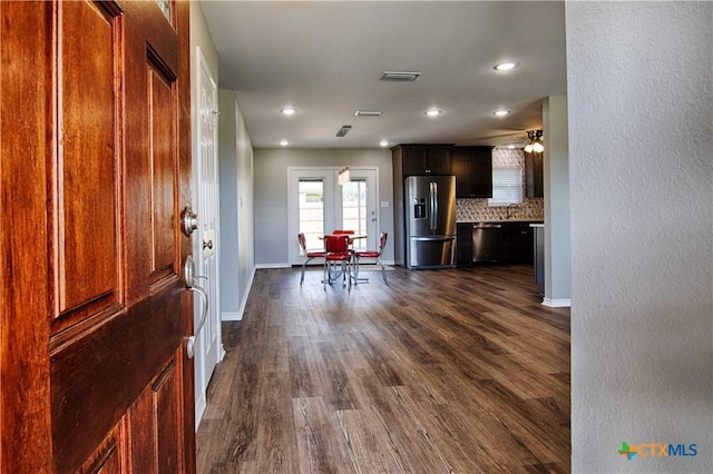 foyer with dark wood-type flooring, recessed lighting, visible vents, and baseboards