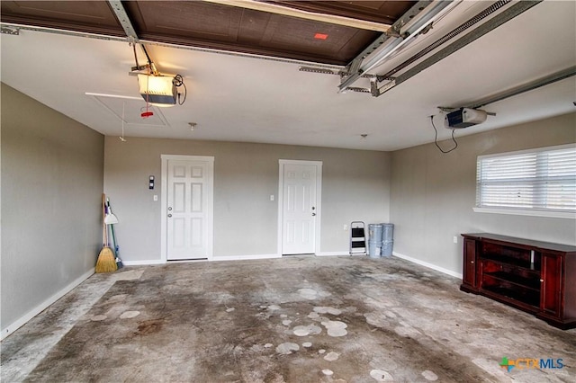 garage with baseboards and a garage door opener