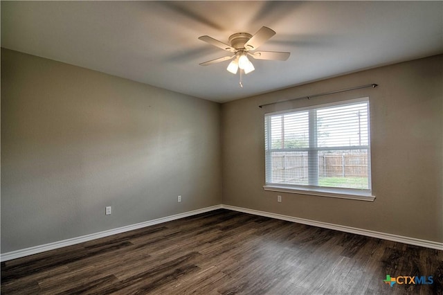 unfurnished room featuring a ceiling fan, baseboards, and dark wood-style flooring