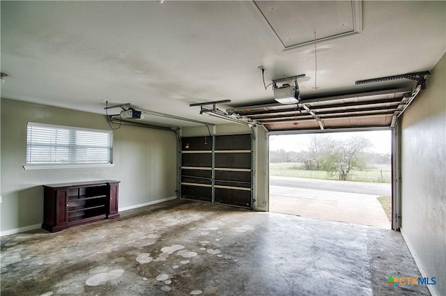 garage with baseboards and a garage door opener