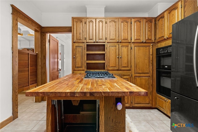 216 E Cedar St, Seguin, TX 78155 - kitchen featuring wooden counters, open shelves, freestanding refrigerator, light tile patterned flooring, and crown molding