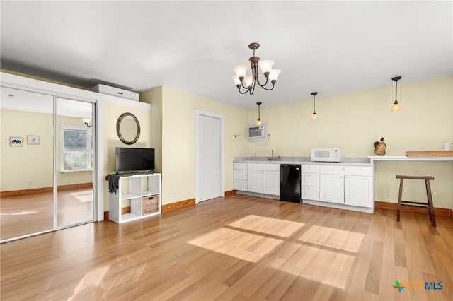 216 E Cedar St, Seguin, TX 78155 - kitchen with white microwave, dishwasher, light wood-style flooring, and white cabinets