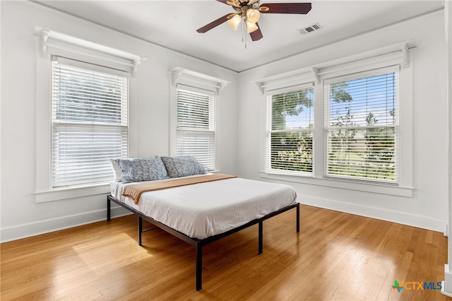216 E Cedar St, Seguin, TX 78155 - bedroom with baseboards, light wood-style flooring, and a ceiling fan