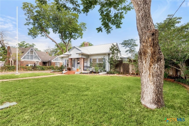 216 E Cedar St, Seguin, TX 78155 - view of front of property featuring a chimney, metal roof, a porch, and brick siding