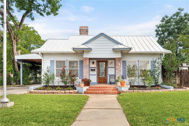 216 E Cedar St, Seguin, TX 78155 - view of front of property featuring a chimney, a standing seam roof, metal roof, an attached carport, and a porch