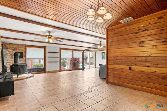 216 E Cedar St, Seguin, TX 78155 - unfurnished living room with ceiling fan, light tile patterned flooring, a wood stove, wood ceiling, and a chandelier