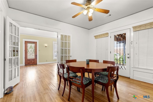 216 E Cedar St, Seguin, TX 78155 - dining space with light wood-type flooring, healthy amount of natural light, and ceiling fan
