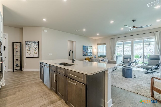 433 Skipping Cedar St, San Marcos, TX 78666 - kitchen with a sink, open floor plan, stainless steel dishwasher, a ceiling fan, and dark brown cabinetry