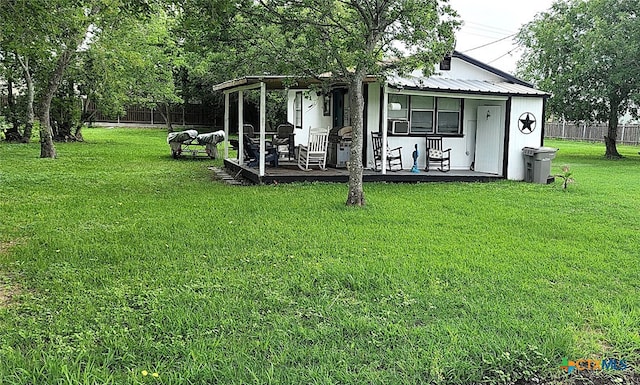 view of yard featuring fence and covered porch