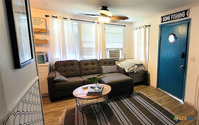 living room with light wood-style flooring and ceiling fan