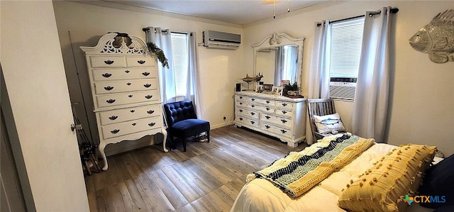 bedroom featuring baseboards, cooling unit, an AC wall unit, and dark wood finished floors