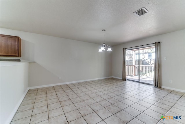 unfurnished room with baseboards, visible vents, a textured ceiling, a chandelier, and light tile patterned flooring