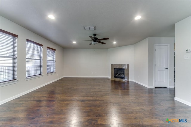 unfurnished living room featuring dark wood-style floors, a premium fireplace, visible vents, and recessed lighting