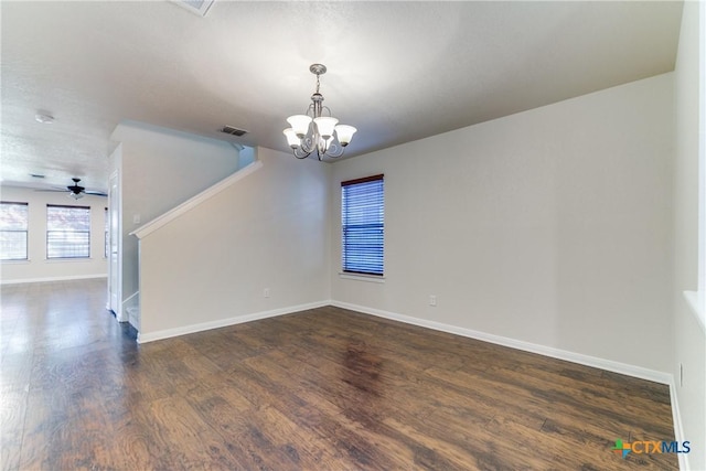 spare room with dark wood-style floors, visible vents, stairway, a textured ceiling, and baseboards