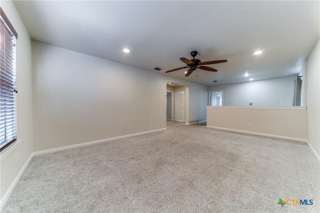 spare room featuring arched walkways, ceiling fan, visible vents, and recessed lighting