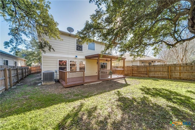 rear view of property featuring a fenced backyard, a yard, a deck, and central AC unit