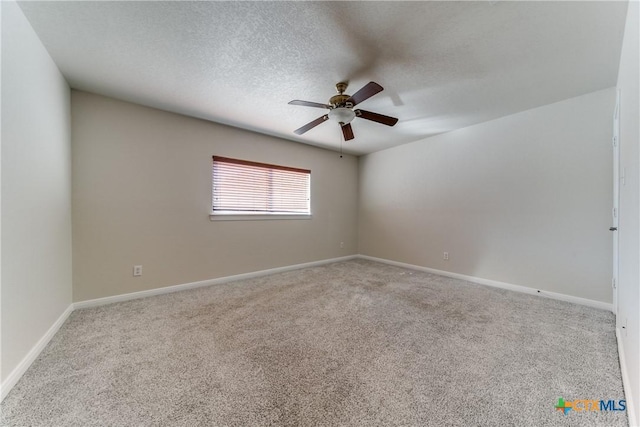 unfurnished room with a textured ceiling, baseboards, and light colored carpet