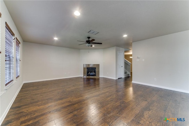 unfurnished living room featuring recessed lighting, visible vents, a tiled fireplace, dark wood-type flooring, and ceiling fan