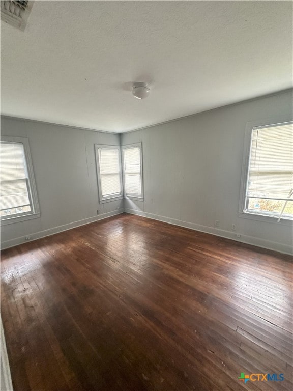 empty room featuring dark wood-type flooring