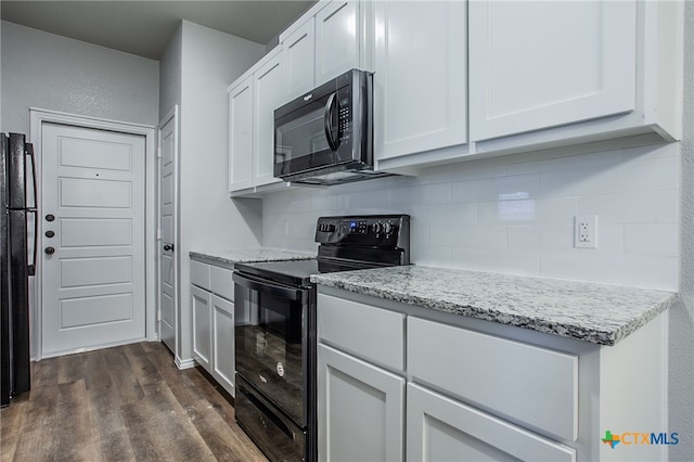 kitchen with light stone countertops, white cabinetry, dark hardwood / wood-style flooring, decorative backsplash, and black appliances