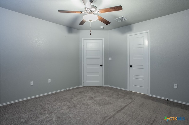 spare room featuring carpet flooring and ceiling fan