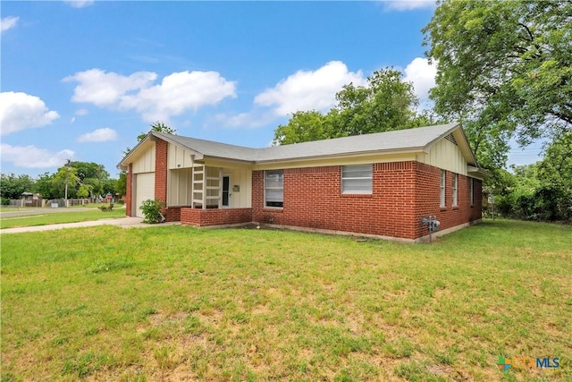 single story home with board and batten siding, brick siding, an attached garage, and a front yard
