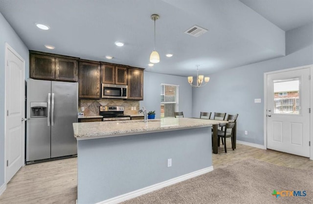 832 Paseo Del Plata, Temple, TX 76502 - kitchen featuring stainless steel appliances, healthy amount of natural light, dark brown cabinets, a chandelier, and recessed lighting