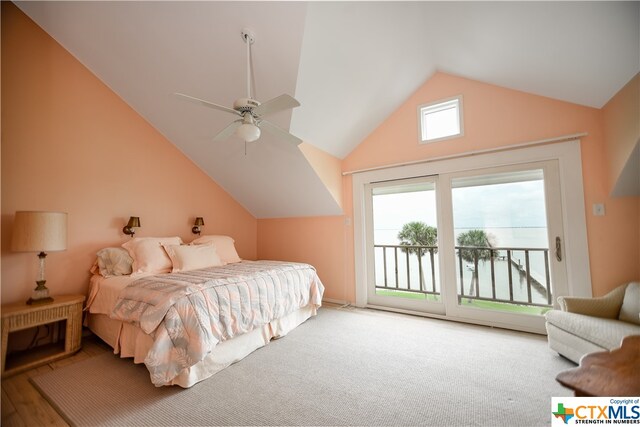 carpeted bedroom featuring access to outside, vaulted ceiling, and ceiling fan