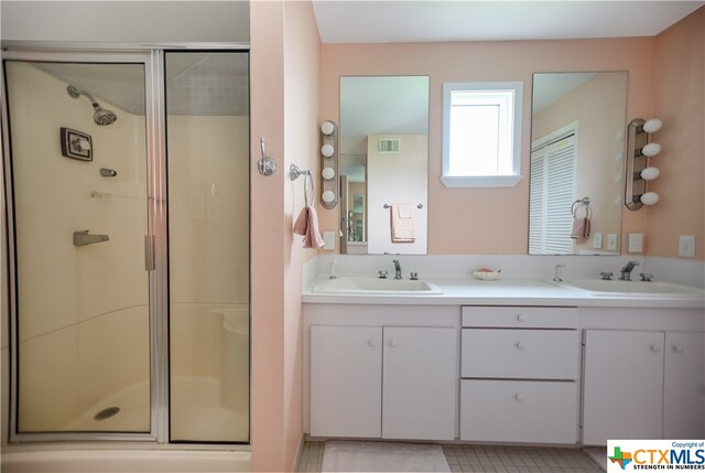 bathroom featuring vanity and a shower with door