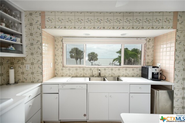 kitchen featuring white cabinets, stainless steel refrigerator, sink, and dishwasher